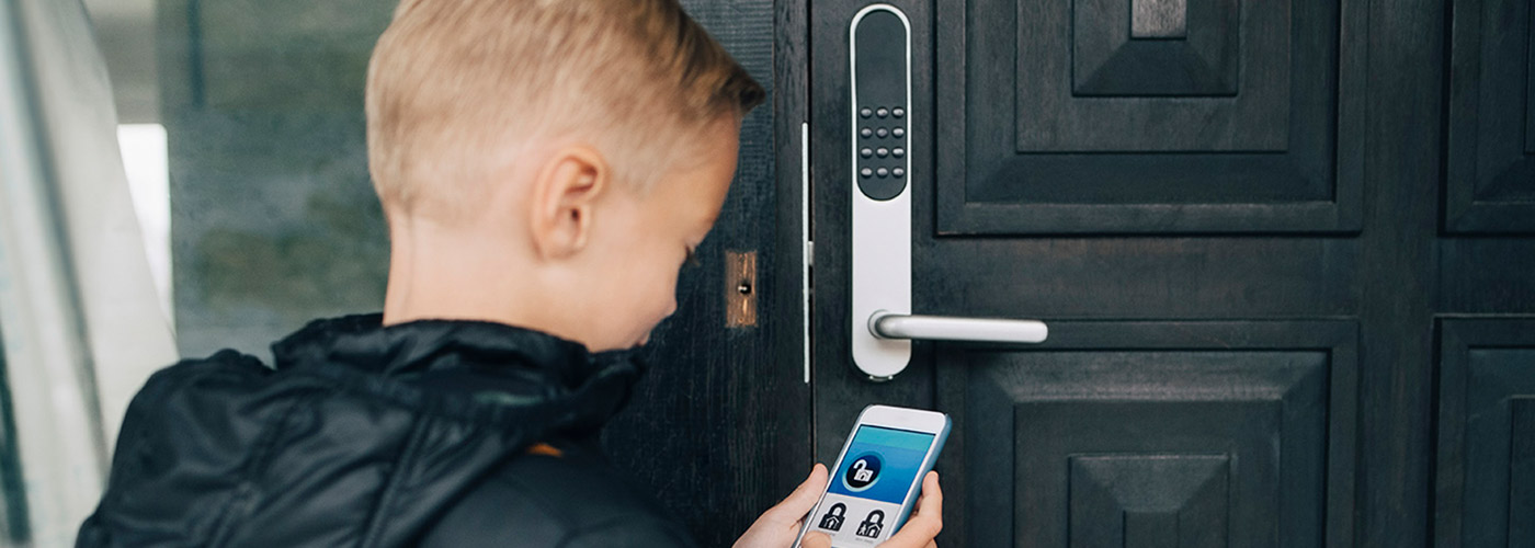 Connected Living Boy Opening Home with Connected Device protected by Assurant